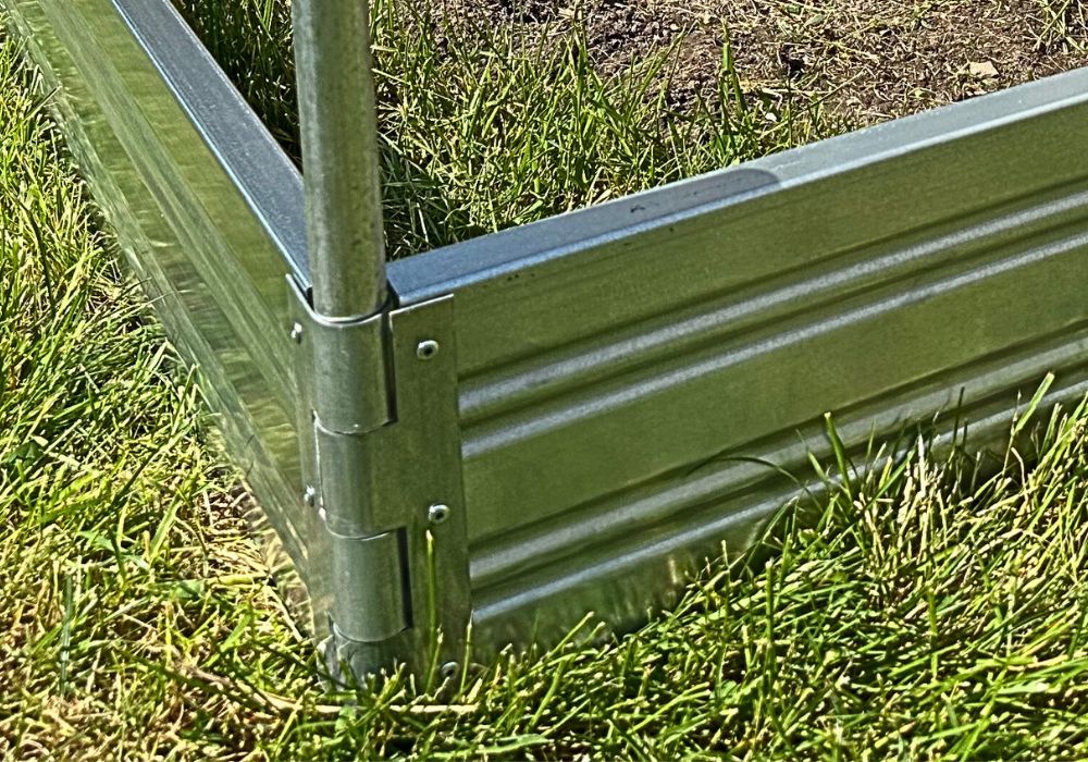 Green metal raised Planta garden bed corner on grass