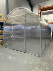 Metal Sigma 250 (Gen III) greenhouse structure in a warehouse setting - Planta Greenhouses EU.
