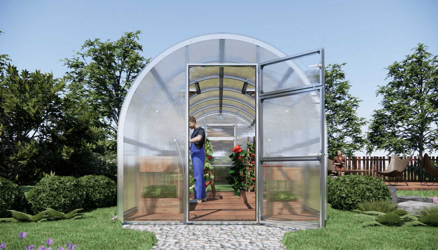Arc-shaped Sigma 2.5x6 (Gen III) greenhouse with a person inside, surrounded by trees and greenery.