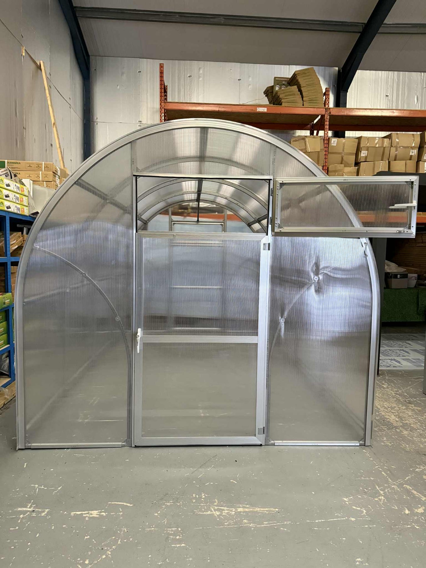 Sigma 250 (Gen III) greenhouse with transparent panels in a warehouse setting