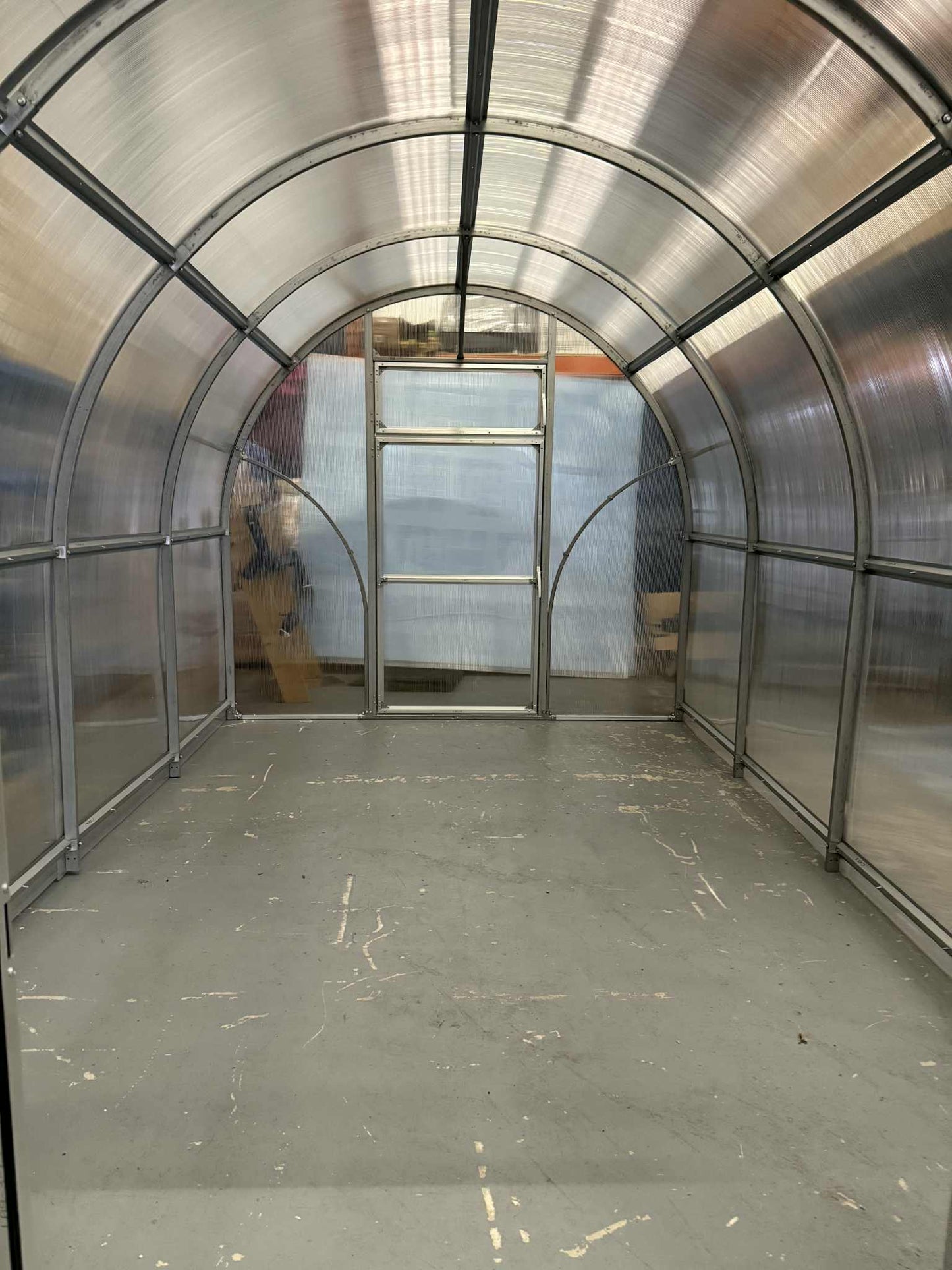 Interior of a Sigma 250 (Gen III) greenhouse with curved walls and a door.